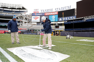 New York Yankees grounds crew members spent weeks implementing a football field into a baseball park. 