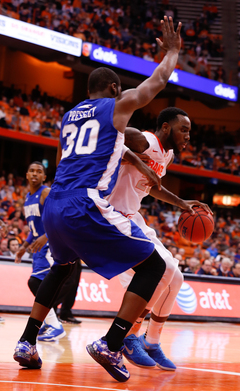 Christmas spins around Pressley as he looks for a shot in the lane. 