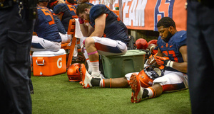 (From left) Robert Welsh and Micah Robinson sit in despair during Syracuse's 28-6 loss to Louisville on Friday in the Carrier Dome after quarterback Terrel Hunt left with a leg injury.