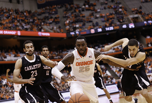 Syracuse forward Rakeem Christmas scraps for a loose ball against Carleton's Phil Scrubb (23) and Guillaume Payen Boucard (31) during SU's exhibition victory.