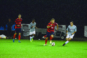 Julian Buescher dribbles past a Colgate defender with the ball. He's been a pivotal part of Syracuse's increased offensive production the last three games.