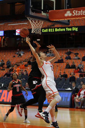 Freshman Julia Chandler tries to get off a shot under the hoop Monday night. She was one of three SU centers to struggle down low in a 71-53 loss to Louisville.