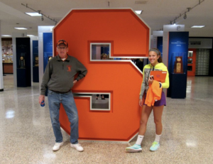 John Prichard poses with his granddaughter, Alicia Hansen, in Manley Field House.