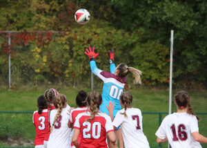 Sam Haley, in blue, recorded over 900 saves as a high school varsity goalie. 