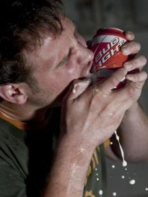 Brian Skiba, a senior in the school of Information Studies, shotguns an orange and white SU themed can of Bud Light. Syracuse was chosen as one of the 27 schools to get the promotional cans, which were sold in stores around campus. The campaign ended when university officials objected.