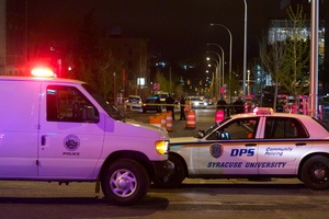 Police cars block the crime scene on University Avenue.  A shooting took place near Syracuse University Campus on Saturday.