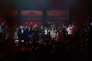 The One World Concert artists wave to the crowd as they conclude their rendition of John Lennon's 