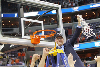 Head coach Jim Boeheim holds up the net after their win over Marquette.