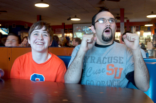 Sam Donnelly (right) a sophomore psychology major and Kelly Punch, a student from Hobart and William Smith College, nervously watch the matchup between Syracuse and Marquette at Varsity Pizza.