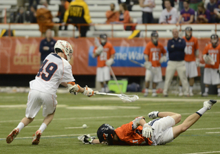 Paolo Cifferi chases down a ground ball with a Hobart Statesmen sprawled on the ground. Cifferi played some of his first significant minutes of the season Tuesday.