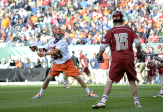 Scott Loy winds up for a shot in front of Denver's Drew Babb.