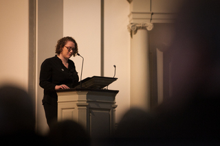 Erin Carhart, a Remembrance Scholar, speaks during the commemoration about the importance of acting forward despite incidences of tragedy. 