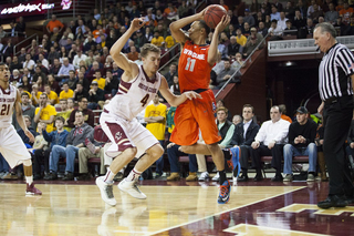 Ennis toes the baseline and looks for an open teammate while falling out of bounds. 