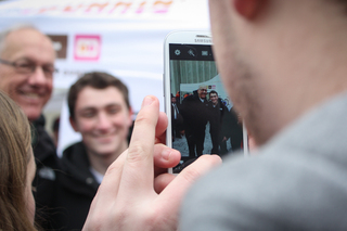 Jim Boeheim takes a photo with a fan outside of Gate E of the Carrier Dome.