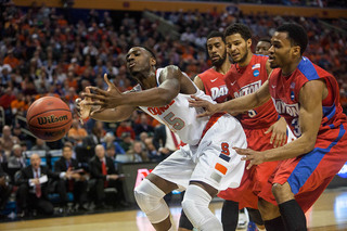 Christmas lets the ball bounce off his fingertips with two Dayton players close behind. 