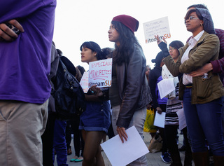 Students hold posters during the 