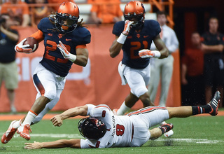 Gulley runs around Louisville punter Ryan Johnson.