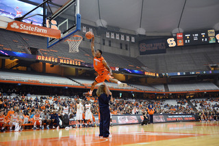 Freshman forward Chris McCullough clears a girl holding a Jim Boeheim 