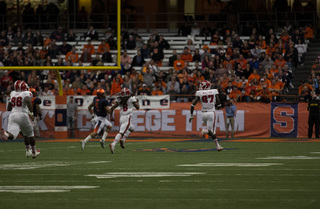 N.C. State defensive end Pharoah McKever coasts to the end zone on his pick-six as Long attempts to run him down.