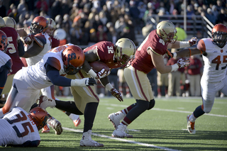 SU defensive end Micah Robinson tries to bring down Eagles running back Jon Hilliman.