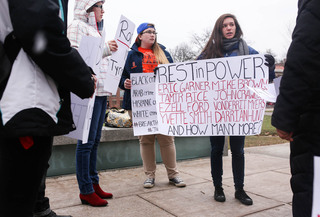 Marissa Mele, a sophomore environmental engineering major, and other rally-goers prepare to protest in front of Hendricks Chapel.