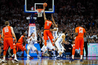 Chris McCullough skies for a layup, as Trevor Cooney (10) and Kaleb Joseph (14) look on. 