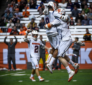 Lecky celebrates with another Syracuse player after scoring against Brennan Donville. Lecky had three goals for the night.