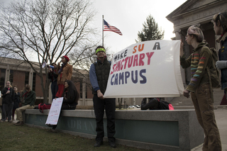 Students hold a sign throughout the entire rally that says 